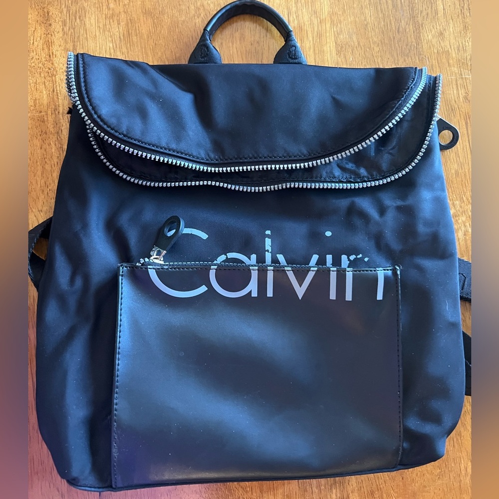 GUC Calvin Klein backpack. Black with distressed lettering. Lots of pockets!